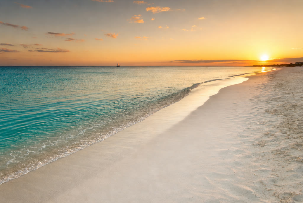 An empty Caribbean beach at sunset